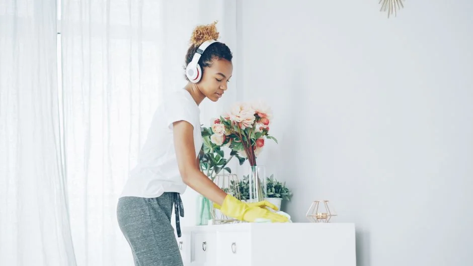 Cleaner using a vacuum in a stylish indoor setting, showcasing cleaning equipment and techniques.